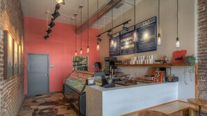 Un café acogedor con mostrador, zona de estar y cartel de menú.