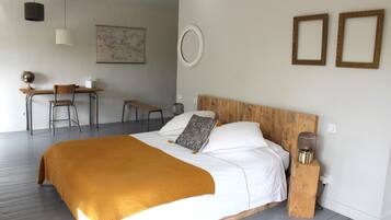 A bedroom with a wooden bed, a desk, and a chair.