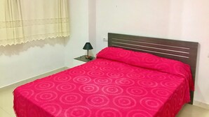 A bedroom with a bed, a nightstand, a lamp, and a window with curtains. - GREAT APARTMENT FOR HOLIDAY RENT RINCON DE LOIX R059 (Benidorm)