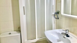 A bathroom with a toilet, a shower with a glass door, and a sink with a mirror. - GREAT APARTMENT FOR HOLIDAY RENT RINCON DE LOIX R059 (Benidorm)
