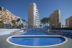 A heated pool, pool loungers