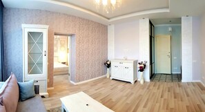 Relax in this stylish living room with a sofa, coffee table, and cabinet.