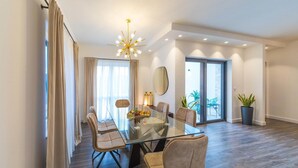 A modern dining area with a glass table, leather chairs, and a chandelier. - Awesome home in Sibenik (Sibenik)
