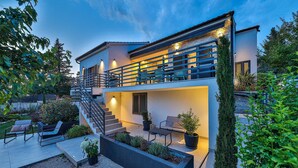 A modern two-story house with a balcony, outdoor seating, and a well-maintained garden. - Awesome home in Sibenik (Sibenik)