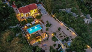 A two-story house with a swimming pool, outdoor seating, and a well-maintained garden. - Awesome home in Sibenik (Sibenik)
