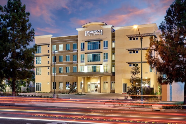 A Staybridge Suites hotel with a modern design, multiple floors, and a well-lit entrance.