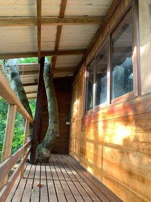 Sit on the covered porch and enjoy the natural surroundings.