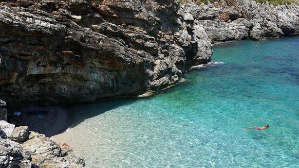 A rocky coastline with clear turquoise water and a person swimming. - Stunning home in Balestrate (Balestrate)