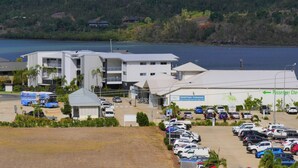 A marina with a building labeled "Maritime Terminal" and a parking lot filled with cars. - Spa Haven 17B (Airlie Beach)