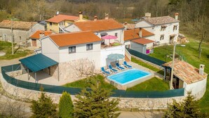 A residential property with a swimming pool, multiple houses, and a view of a forested area. - Stunning private villa for 6 people with private pool, A/C, WIFI, TV and terrace (Pazin)