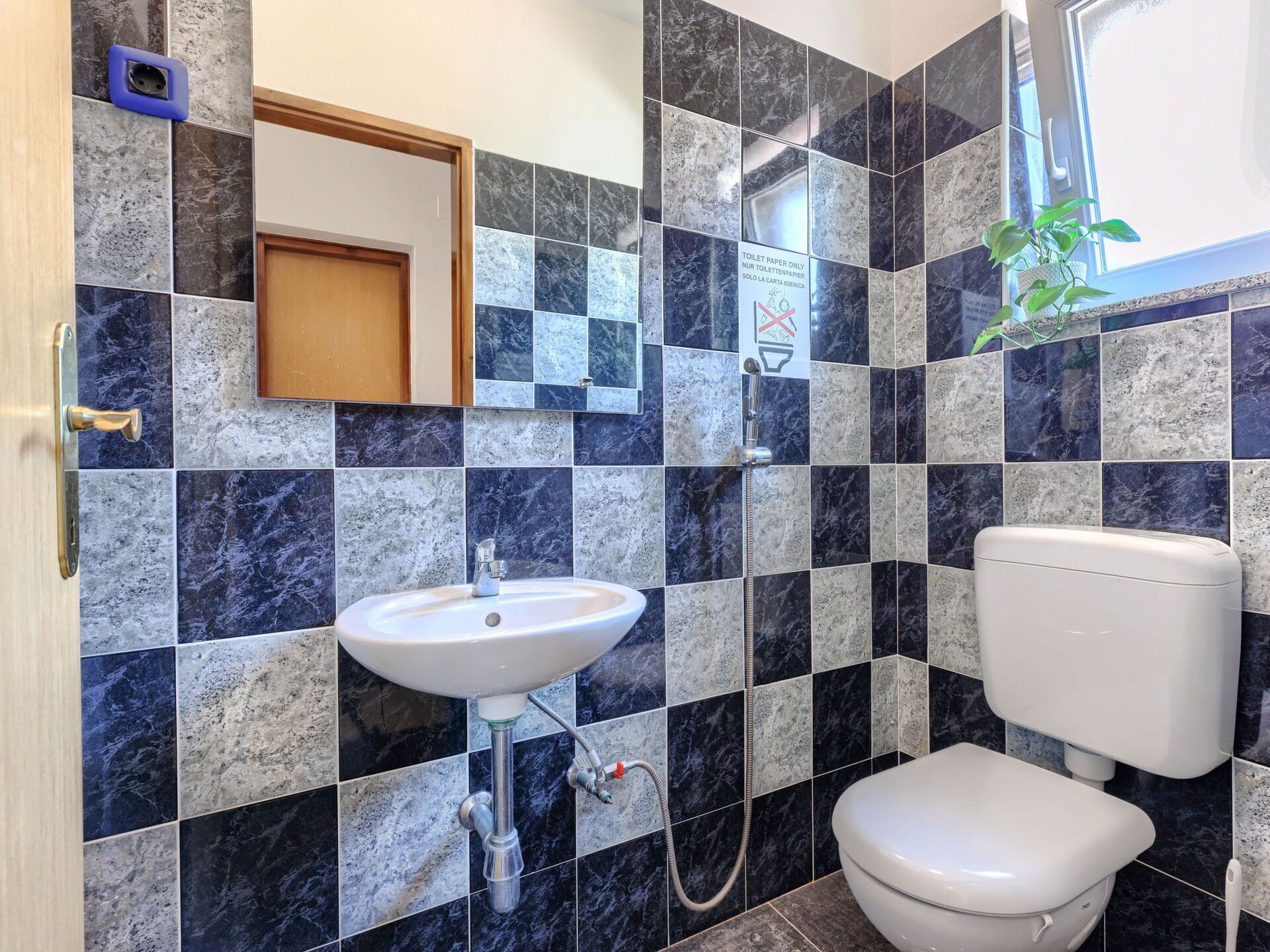 A bathroom with a sink, toilet, and shower.