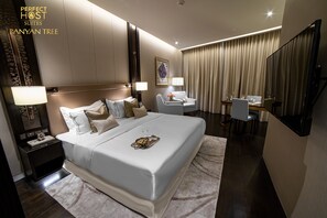 Contemporary hotel room with a large bed, desk, and mirror.