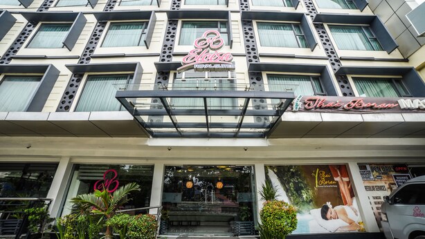 A hotel with a modern facade, a sign for 'Royal Suites', and a Thai Borum massage service. - Maria Eloisa Royal House (Daanbantayan)