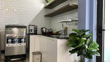 Fridge, microwave, cookware/dishes/utensils, dining tables