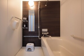 Separate tub and shower, free toiletries, hair dryer, slippers