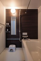 Separate tub and shower, free toiletries, hair dryer, slippers