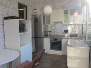 Enjoy cooking in this well-equipped kitchen with a refrigerator, oven, and microwave.