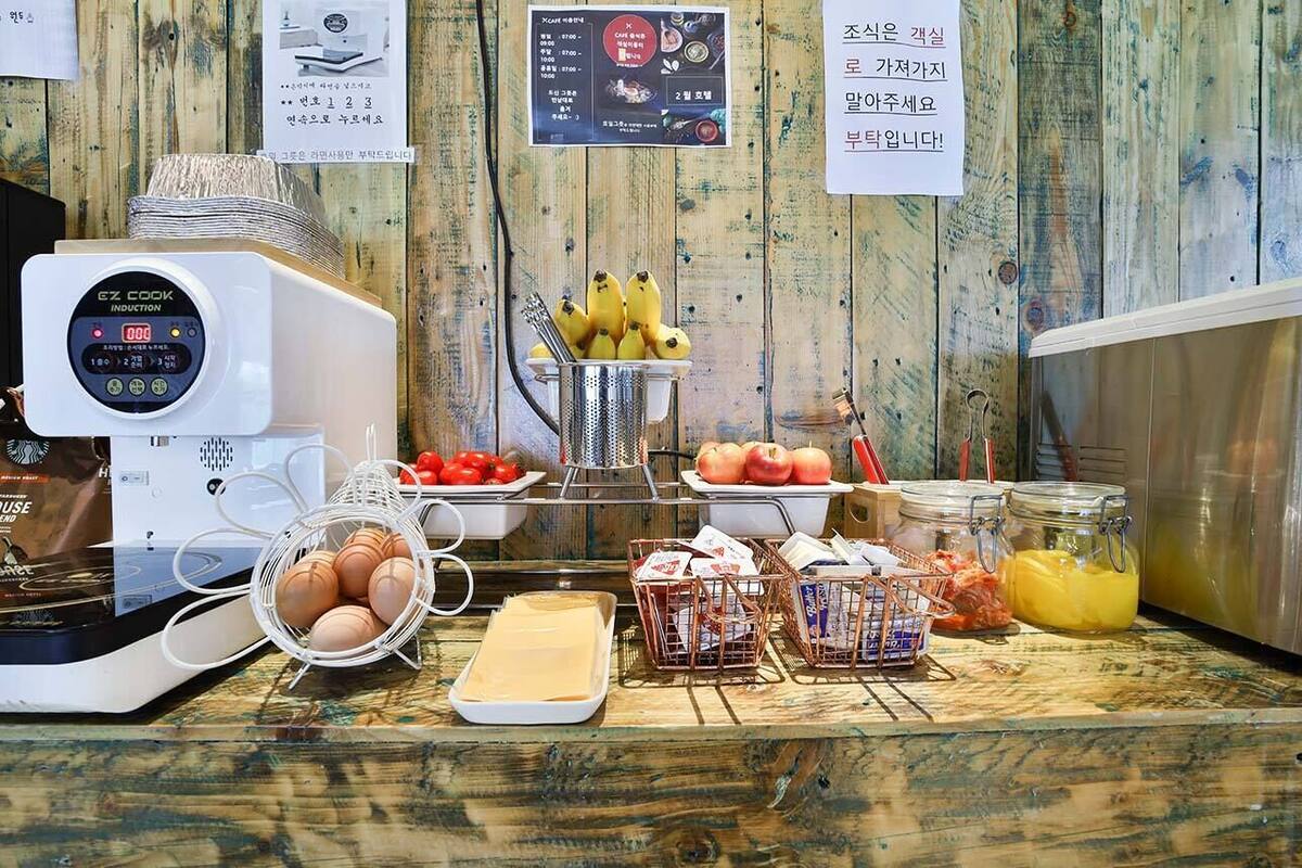 A breakfast buffet with various food items and a coffee machine.