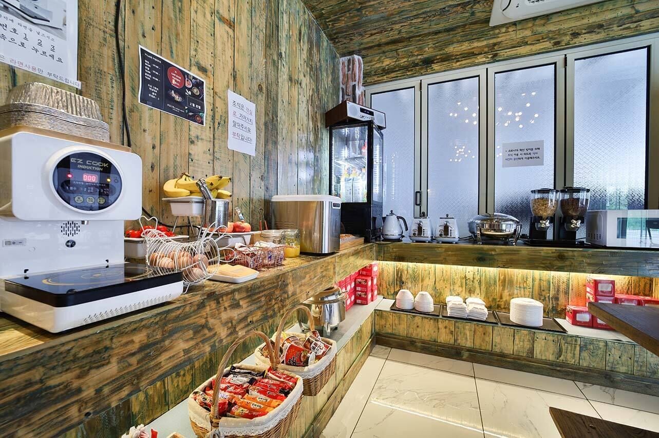 A breakfast bar with a coffee machine, a microwave, and various food items.