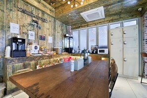 A rustic café interior with a wooden table, coffee machines, and a sign reading 'Brew & Cafe'. - February Hotel Busan Gangseo Annex Building  (Busan)