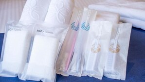 A set of neatly folded towels with labels, including "BODY TOWEL" and "Bath Spa."