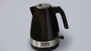 A black and silver electric kettle with a handle and a control knob.