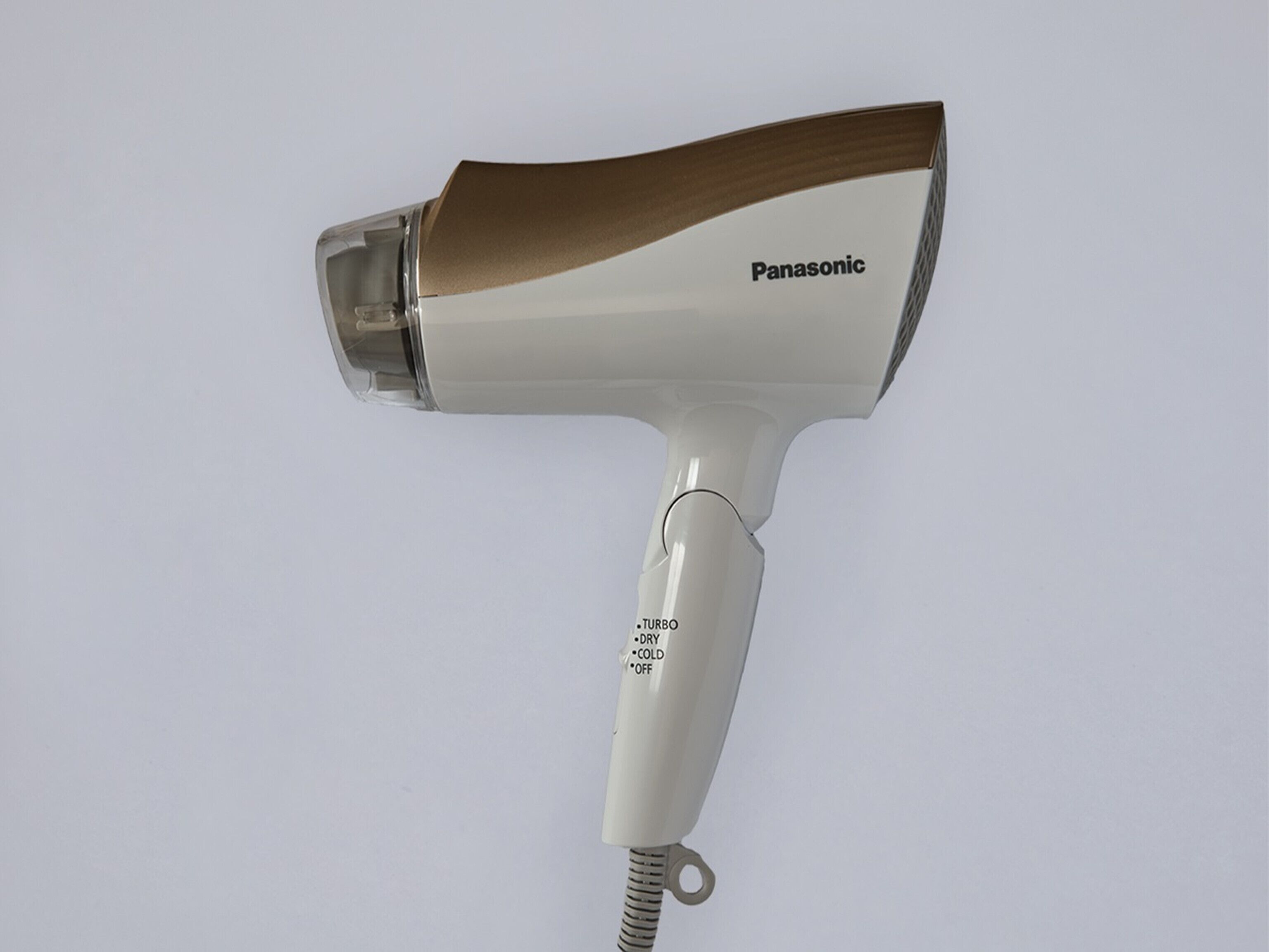 A Panasonic hair dryer with a white and brown design, featuring a label that reads "TURBO DRY COLD OFF".