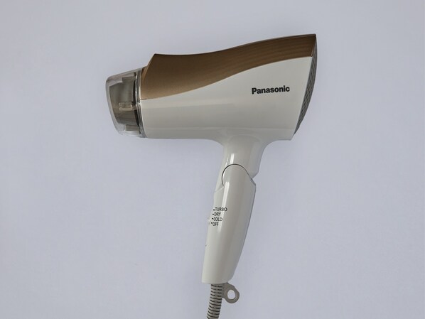 A Panasonic hair dryer with a white and brown design, featuring a label that reads "TURBO DRY COLD OFF".