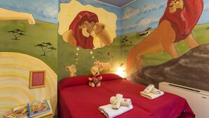 A hotel room with a mural of a lion, a bed with red bedding, a teddy bear, and a framed picture on the nightstand. - Villa / Independent home in Lucca with 4 bedrooms sleeps 8 (Lucca)