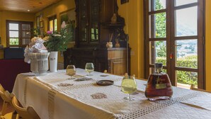 A dining table set with wine glasses, a bottle of liquor, and playing cards. - Villa / Independent home in Lucca with 4 bedrooms sleeps 8 (Lucca)