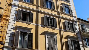 A multi-story building with arched doorways and a shop sign reading "CERAMICA". - Residenza Maritti Classic Rooms (Rome)