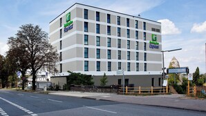A Holiday Inn Express hotel with a modern facade, multiple windows, and a clear sky. - Holiday Inn Express Darmstadt by IHG (Darmstadt)