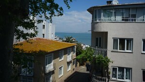 A multi-story building with balconies, a view of the sea, and a clear sky. - My Way Cadde Butik Otel (Adalar)
