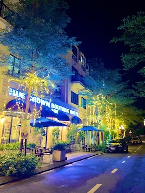 A hotel with a sign reading "Crown Boutique Hotel" and outdoor seating. - Hue Crown Boutique Hotel (Hue)