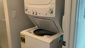 A front-loading washing machine with a control panel, a power outlet, and an ENERGY GUIDE label. - The cottage of lake seminole (Donalsonville)
