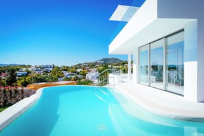 Outdoor pool, an infinity pool, pool loungers