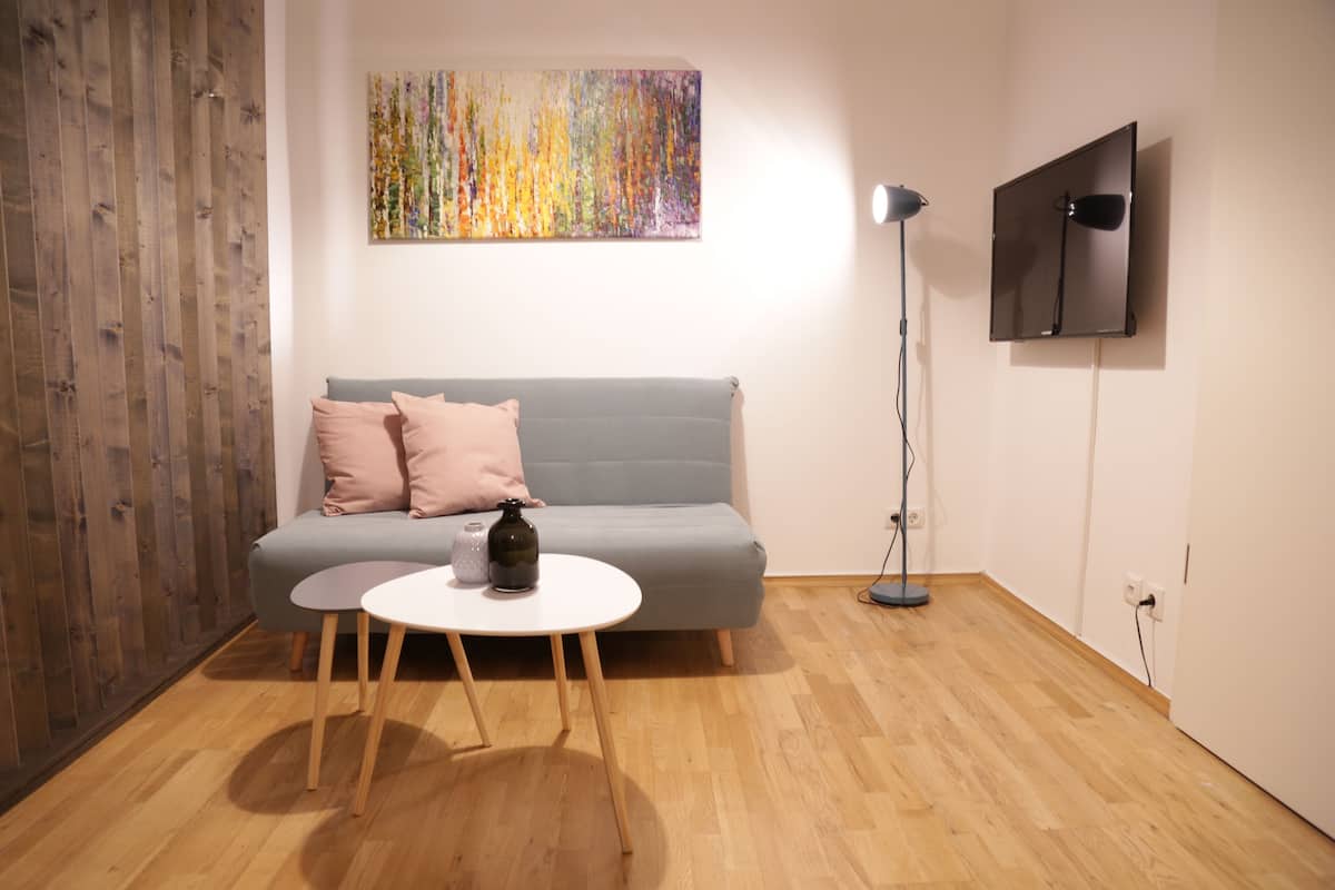 Studio with Garden View | Living area | Flat-screen TV