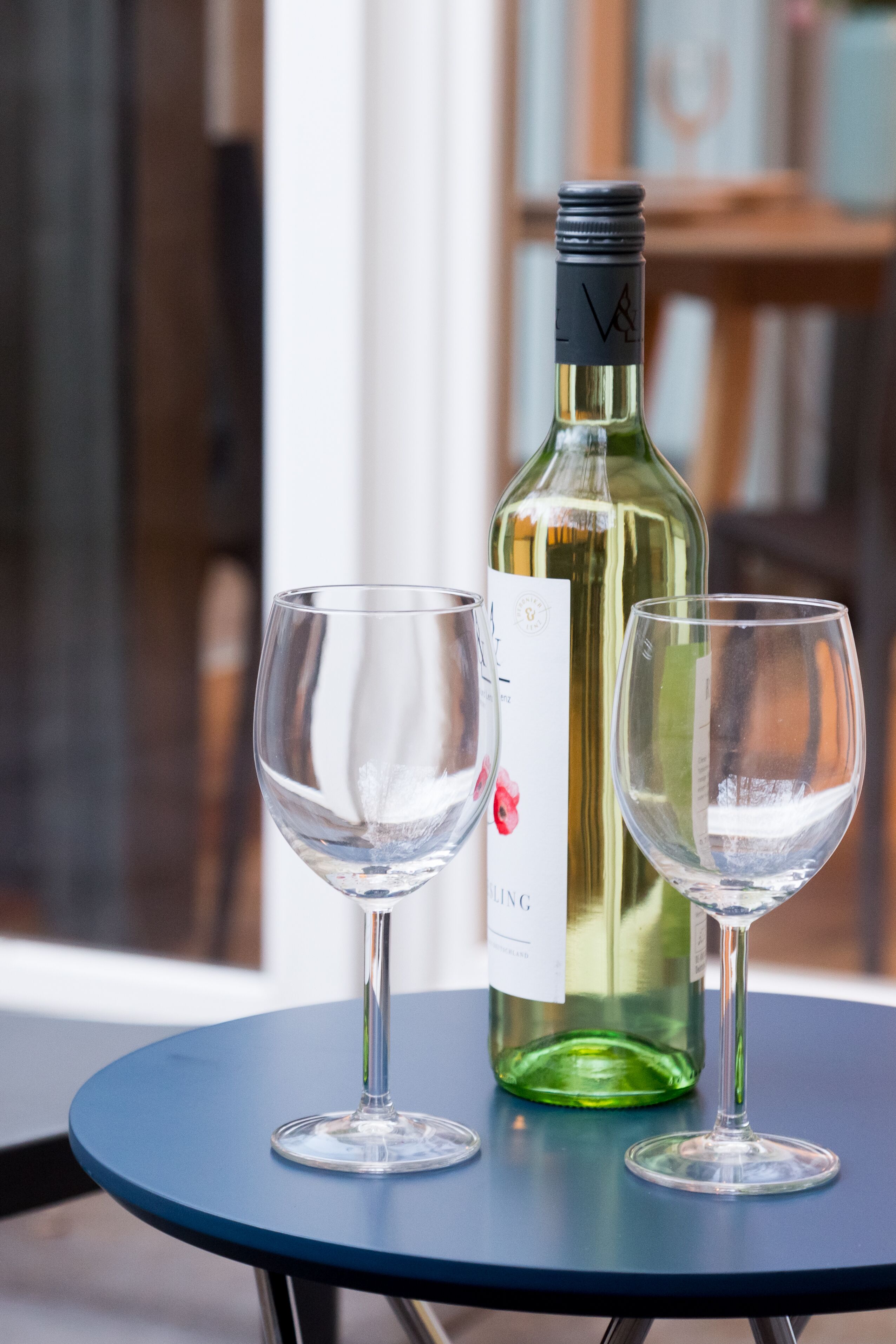 A table with a wine bottle and two glasses.