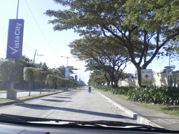 A street with a sign for Vista City and a Camella sign.