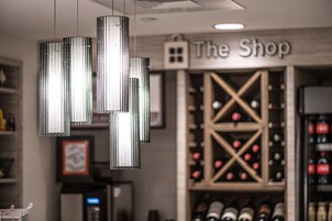 A wine cellar with a wine rack and a sign that reads "The Shop".