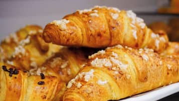 A plate of croissants with chocolate chips and nuts.