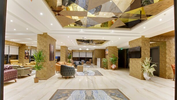 A spacious lobby with a marble floor, comfortable seating areas, and a modern ceiling design. - Newway Hotel (Kocasinan)
