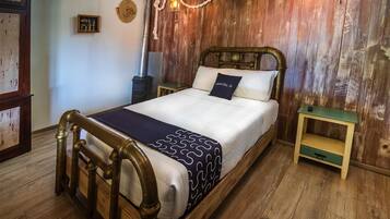 A wooden bed with a headboard, a bedside table, and a nightstand.