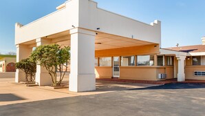 A modern building with a covered entrance and a parking area. - OYO Hotel Elk City OK Route 66 (Elk City)
