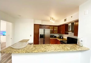 Enjoy cooking in this well-equipped kitchen with a refrigerator, stove, and sink.