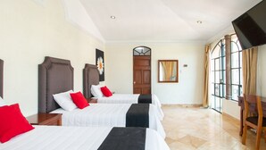 A hotel room with two beds, a wooden door, a large window, and a mirror. - Capital O Hotel San Jose, San Luis PotosÃ­ (San Luis Potosi)