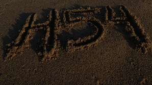 Una playa con olas y la palabra 'LOVE' escrita en la arena.