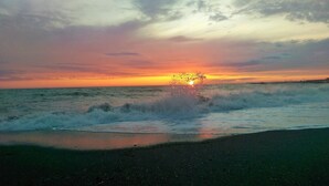 A beach with waves at sunset. - Fantastic new villa near the sea in one of the most beautiful areas of Tuscany  (Pomaia)