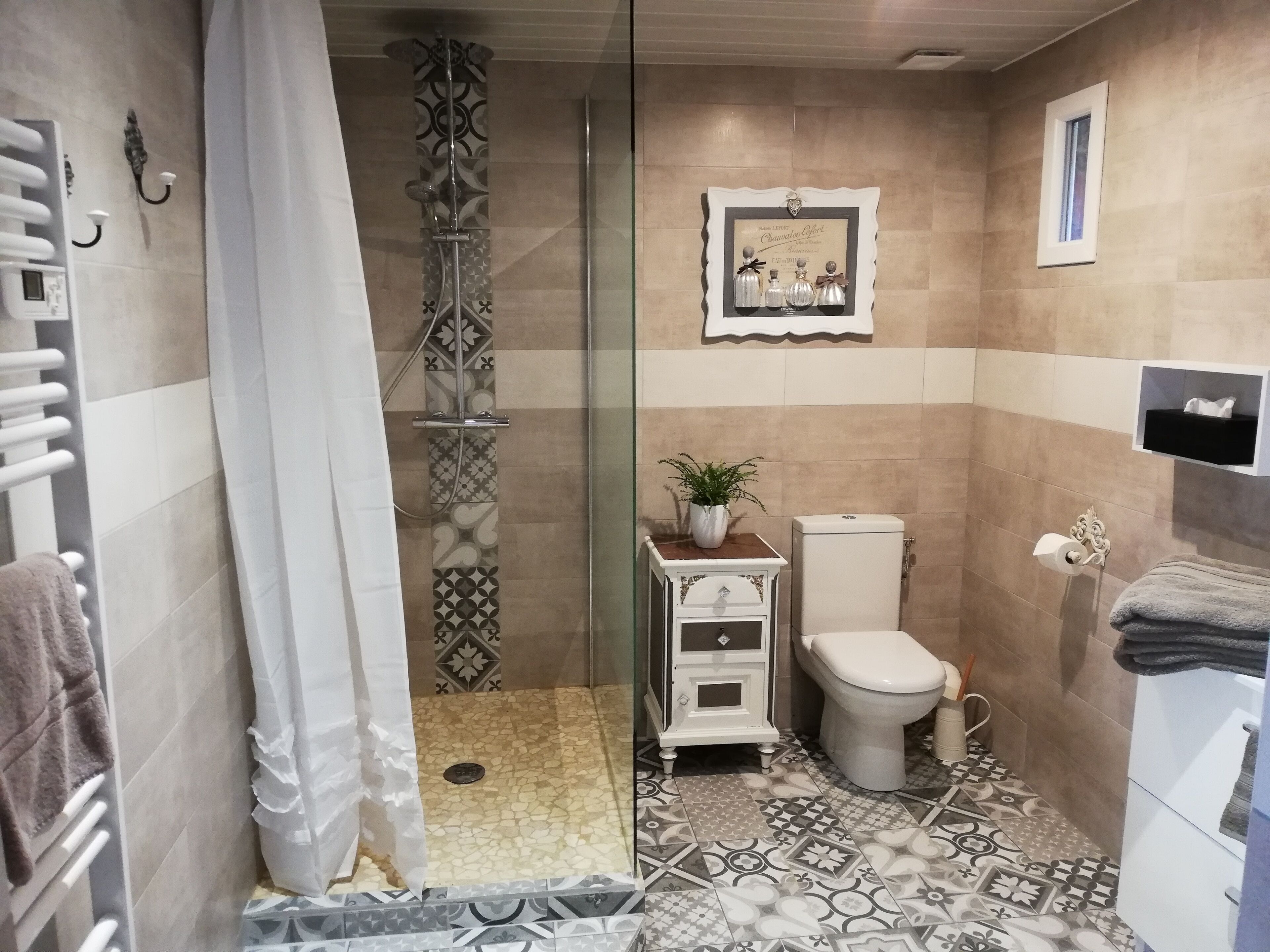 A bathroom with a shower, toilet, and sink.
