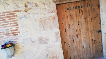 A wooden door with multiple keys hanging on it, indicating a secure entry point.
